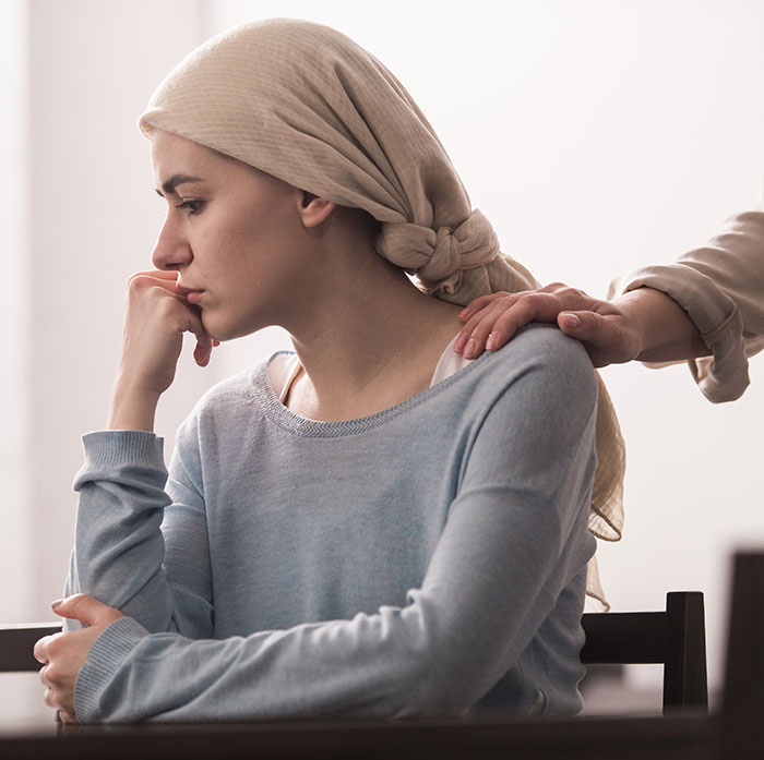 A pensive woman with a headscarf receives comfort from a supportive hand on her shoulder, reflecting on inheritance issues. A pensive woman with a headscarf receives comfort from a supportive hand on her shoulder, reflecting on inheritance issues.