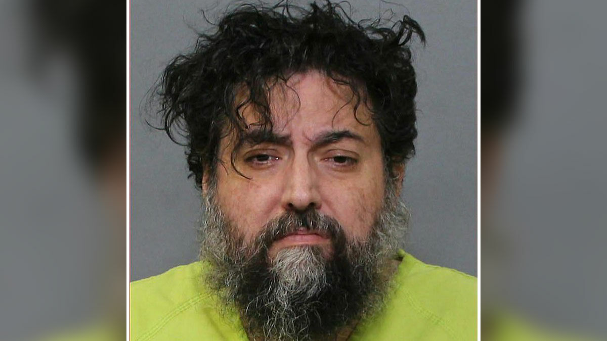 Mugshot of a man with disheveled hair and beard, related to missing teen girl found in ex-con's closet case.