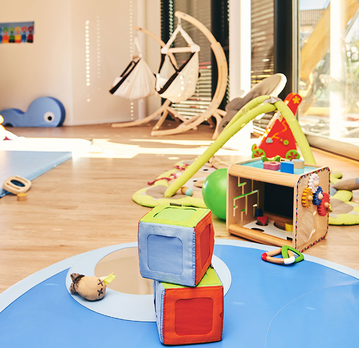 Daycare play area with colorful toys and soft mats, highlighting a space for children to explore and learn. Daycare play area with colorful toys and soft mats, highlighting a space for children to explore and learn.