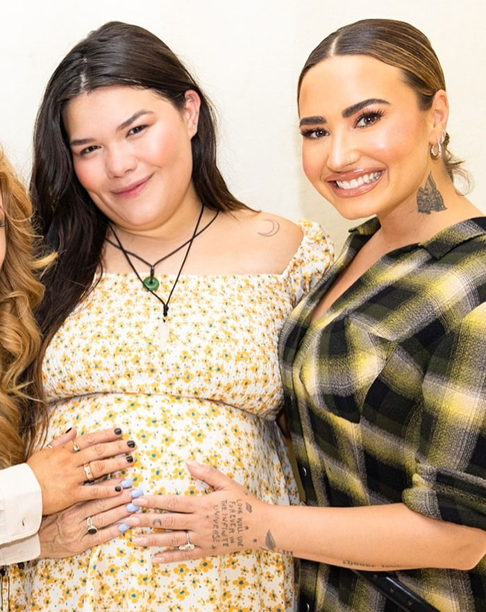 Two individuals smiling together, with one person showing off their tattoos and wearing a plaid shirt, related to a celebrity's skinny frame. Two individuals smiling together, with one person showing off their tattoos and wearing a plaid shirt, related to a celebrity's skinny frame.