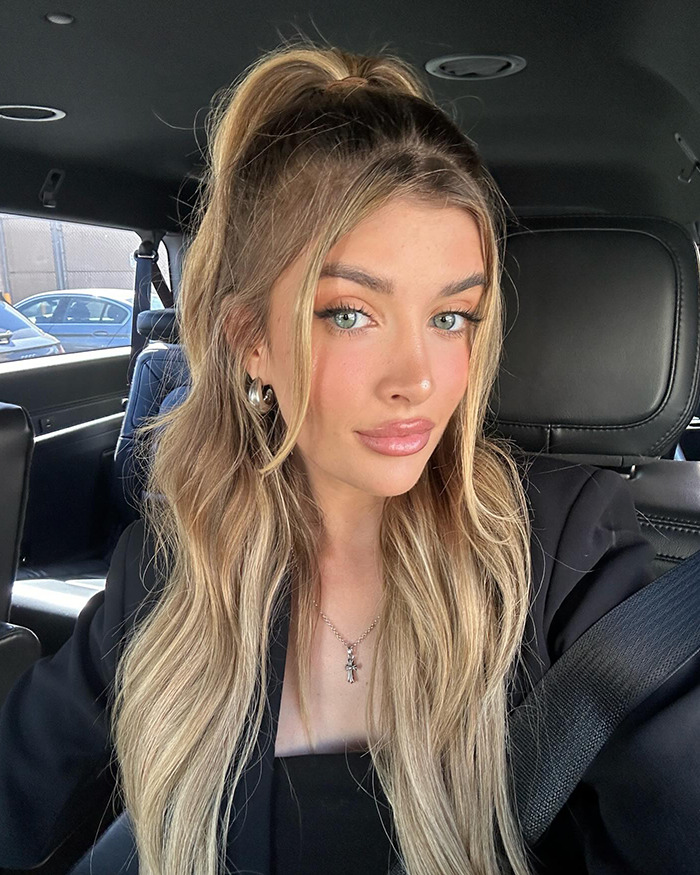 Young woman with long blonde hair in a car, discussing cosmetic surgeries. Young woman with long blonde hair in a car, discussing cosmetic surgeries.