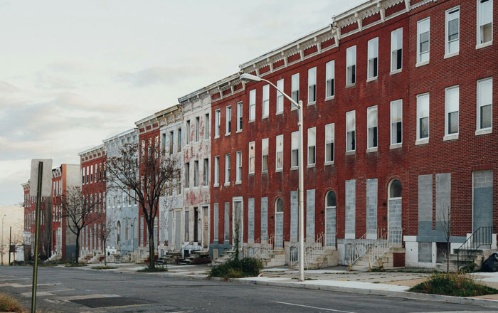 Row of dilapidated buildings on a deserted street, showcasing urban decay in one of America's dirtiest cities. Row of dilapidated buildings on a deserted street, showcasing urban decay in one of America's dirtiest cities.