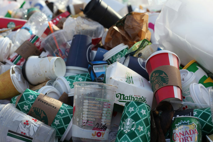 A pile of discarded coffee cups and fast-food containers highlighting America's dirtiest cities issue.