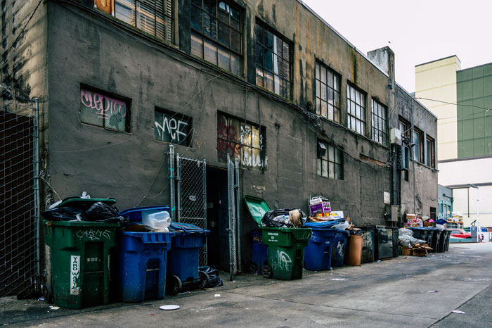 Dirty alley with overflowing trash bins, representing one of America's dirtiest cities. Dirty alley with overflowing trash bins, representing one of America's dirtiest cities.