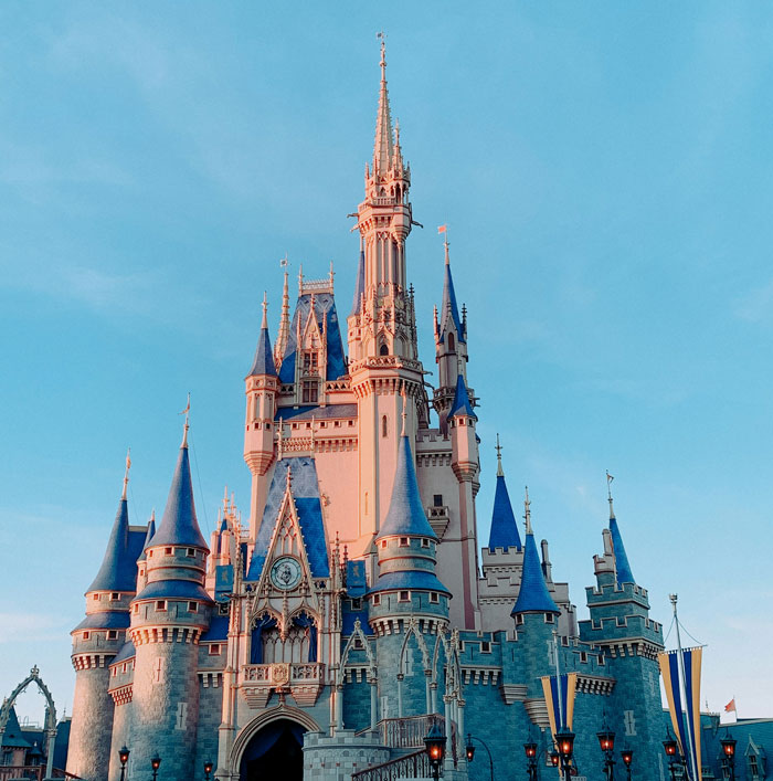 Disney castle under a clear blue sky, celebrating new 2025 discounts. Disney castle under a clear blue sky, celebrating new 2025 discounts.