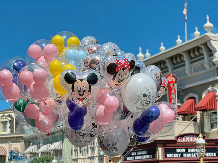 Colorful Disney balloons featuring Mickey and Minnie on a sunny day, in front of a classic Disney building. Colorful Disney balloons featuring Mickey and Minnie on a sunny day, in front of a classic Disney building.