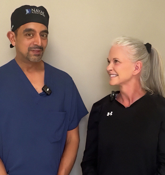 Plastic surgery success: A woman smiling with a professional in surgical attire. Plastic surgery success: A woman smiling with a professional in surgical attire.