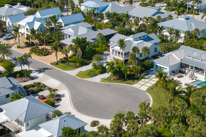 Aerial view of millionaire neighborhood with large houses and lush landscaping in a wealthy residential area. Aerial view of millionaire neighborhood with large houses and lush landscaping in a wealthy residential area.