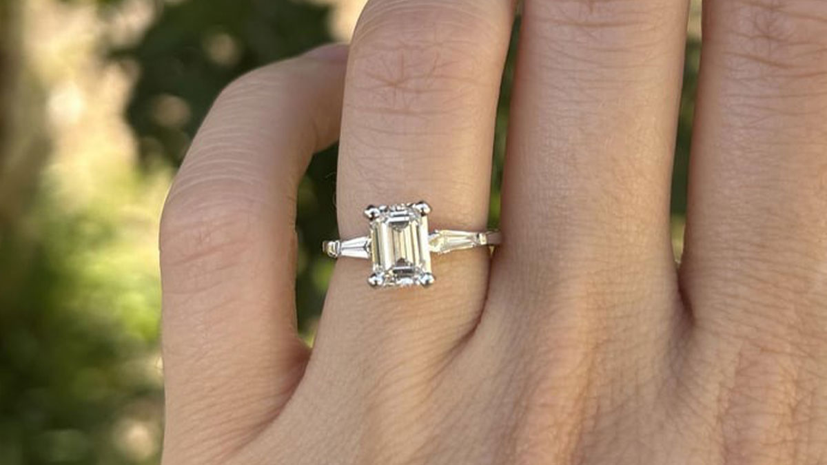 Close-up of a hand wearing a pricey ring given by a millionaire neighbor to his fiancu00e9e for $400.