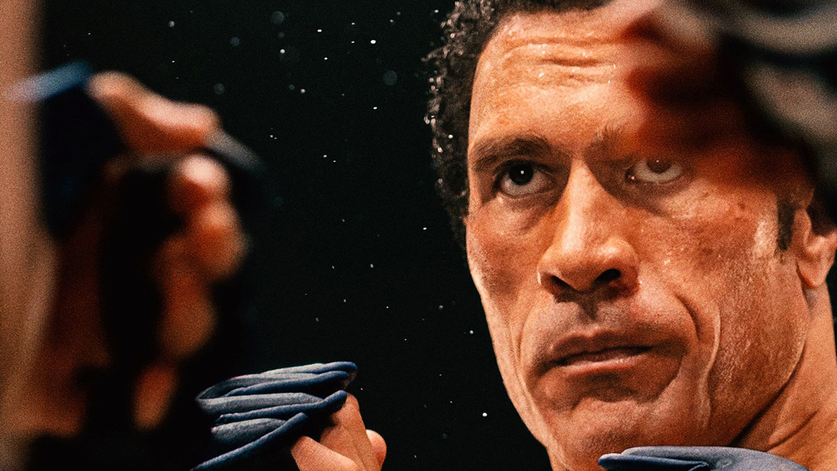 Dwayne Johnson focusing intensely during training, showcasing his impressive transformation for upcoming biopic role.