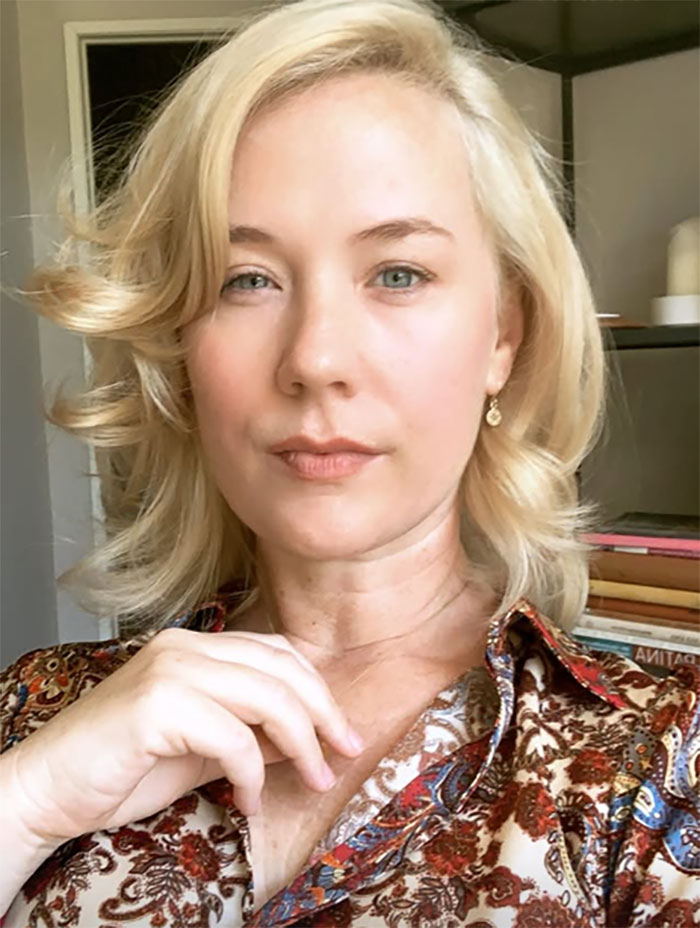 Blond woman in a patterned blouse with books in the background, discussing childhood confusion and deprivation. Blond woman in a patterned blouse with books in the background, discussing childhood confusion and deprivation.