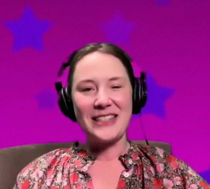 A woman with headphones and a floral shirt against a pink background with stars discusses her childhood experiences. A woman with headphones and a floral shirt against a pink background with stars discusses her childhood experiences.