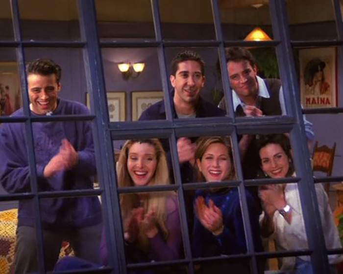 Cast of a popular TV show applauding behind a classic window setup. Keywords: awkward encounter. Cast of a popular TV show applauding behind a classic window setup. Keywords: awkward encounter.