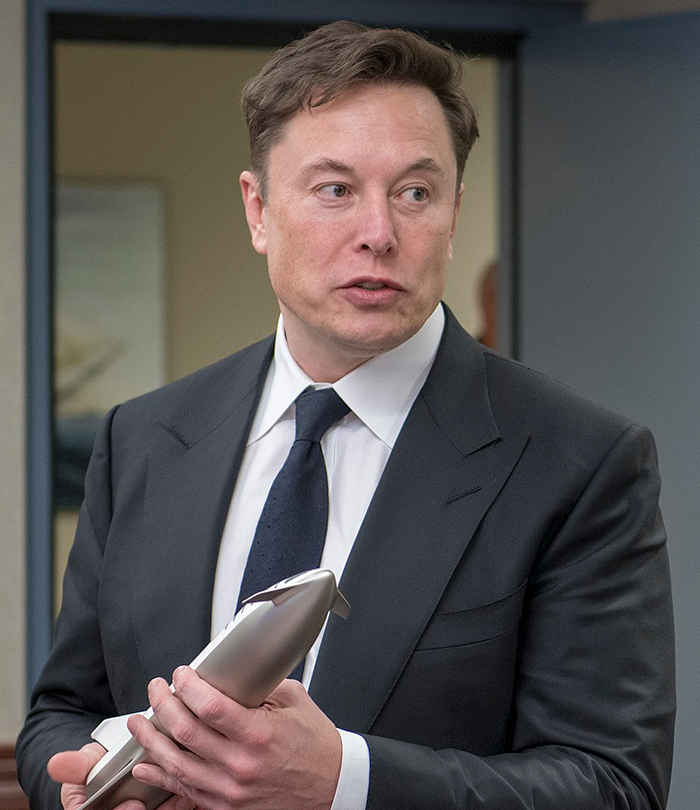 Man in a suit holding a model rocket. Man in a suit holding a model rocket.