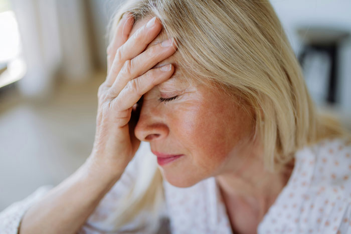 Stressed woman with hand on forehead, showing emotions of drama and wedding secrets affecting big moments. Stressed woman with hand on forehead, showing emotions of drama and wedding secrets affecting big moments.