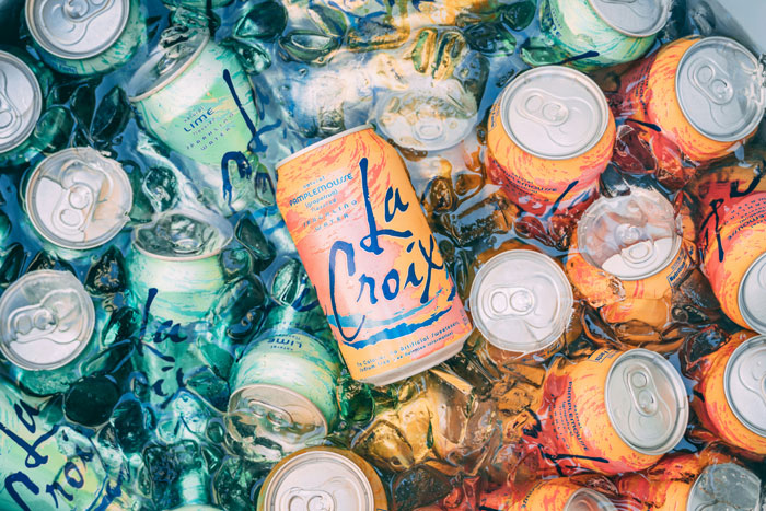 Cans of LaCroix sparkling water submerged in ice. Cans of LaCroix sparkling water submerged in ice.