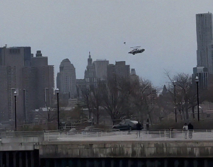 Helicopter over NYC skyline before crash, trees and buildings in the background. Helicopter over NYC skyline before crash, trees and buildings in the background.