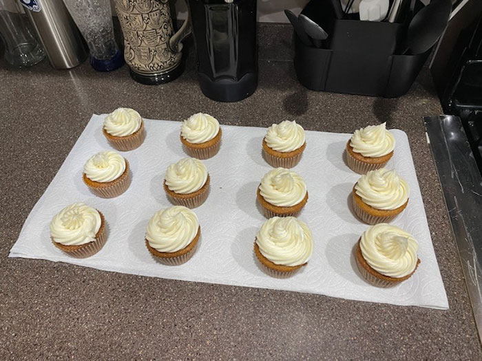 Cupcakes with white frosting on a kitchen counter, illustrating a family gathering before a husband confronts over treatment of pregnant wife. Cupcakes with white frosting on a kitchen counter, illustrating a family gathering before a husband confronts over treatment of pregnant wife.