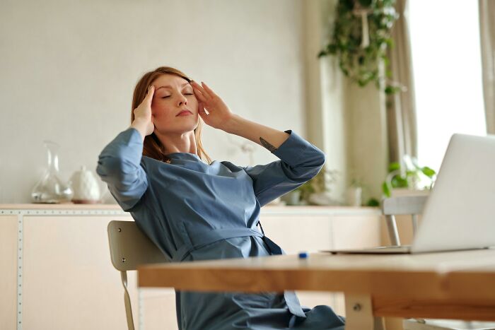 Woman feeling annoyed at a desk, dealing with family and friends over no-gifts rule, sitting in a cozy home office space. Woman feeling annoyed at a desk, dealing with family and friends over no-gifts rule, sitting in a cozy home office space.