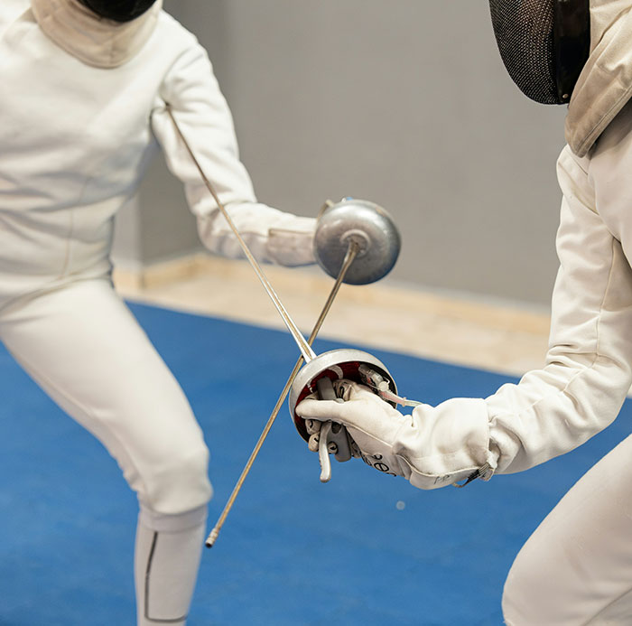Two fencers in action, highlighting competition and disqualification in sports. Two fencers in action, highlighting competition and disqualification in sports.