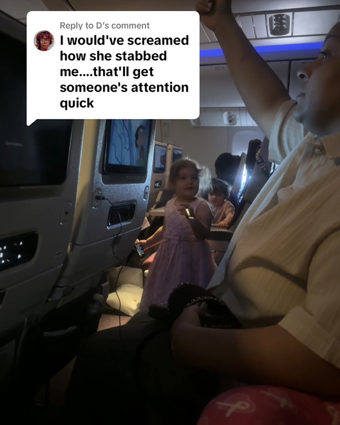 Passenger on flight confronted by child in aisle holding fork, mother asleep nearby. Passenger on flight confronted by child in aisle holding fork, mother asleep nearby.