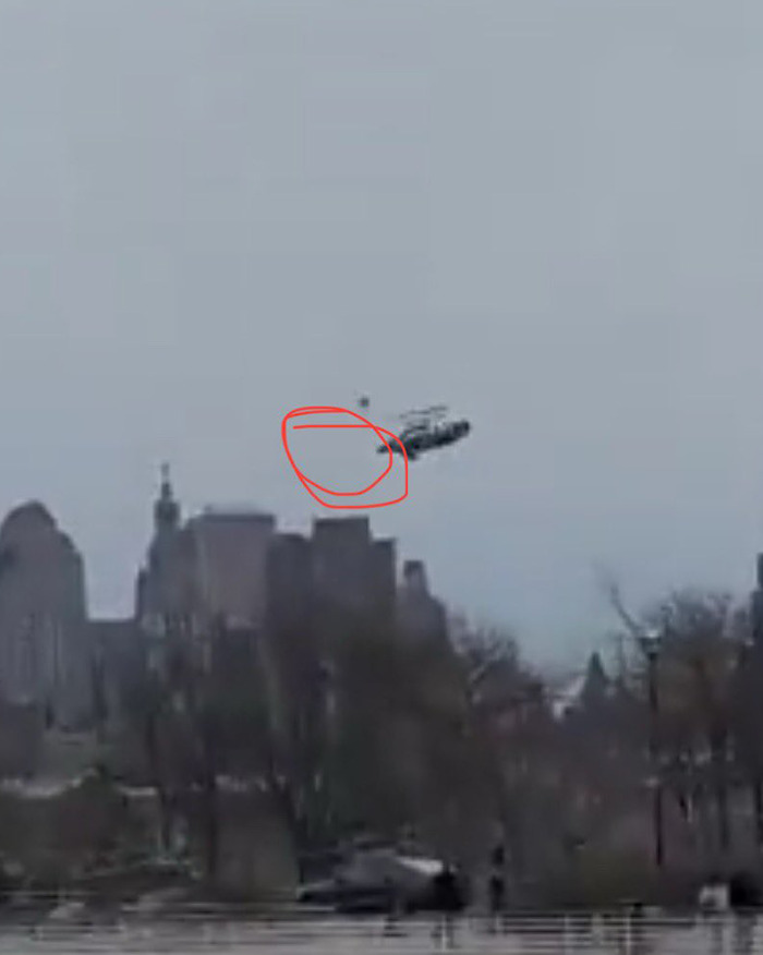 Helicopter in mid-flight before crash, circled area highlighted, potential clue to incident cause. Helicopter in mid-flight before crash, circled area highlighted, potential clue to incident cause.