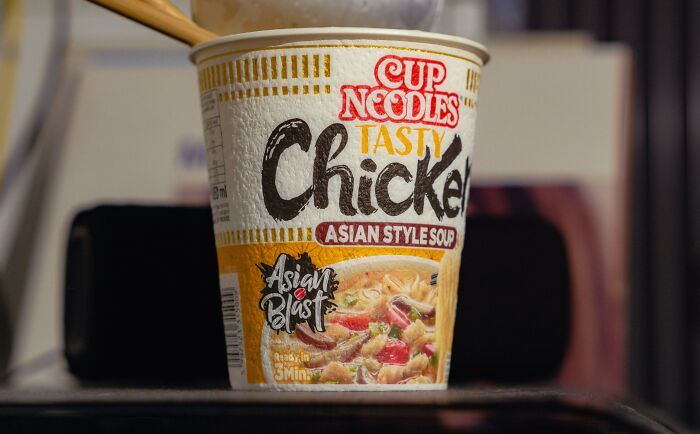 Cup Noodles Tasty Chicken Asian Style Soup on a table, highlighting packaging design for noodle enthusiasts.