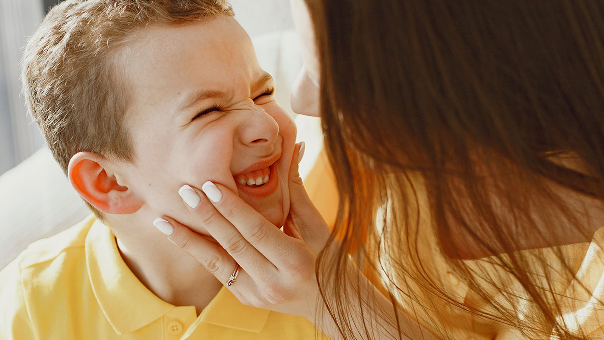 A playful moment between a parent and child, capturing the joy in funny tweets shared by parents.