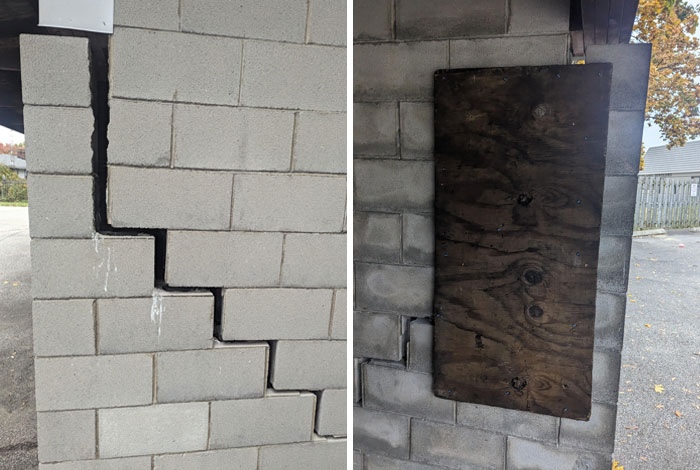 Failed repair attempt with c*****d cinder block wall, poorly patched with wood.