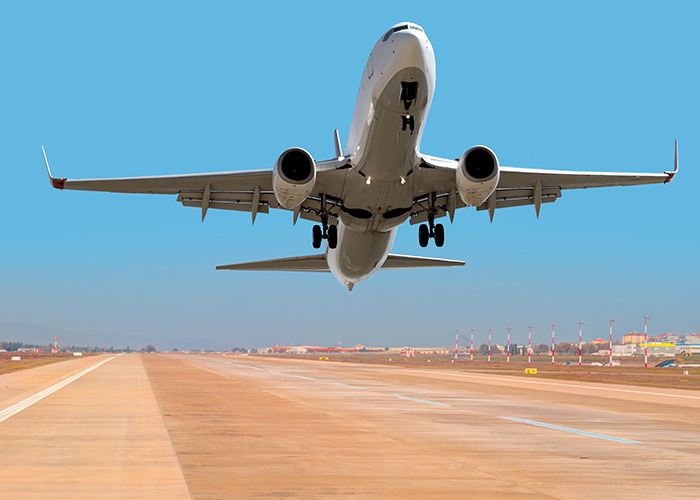 Airplane taking off from runway under clear blue sky, image related to frustrated passengers and airline delays. Airplane taking off from runway under clear blue sky, image related to frustrated passengers and airline delays.