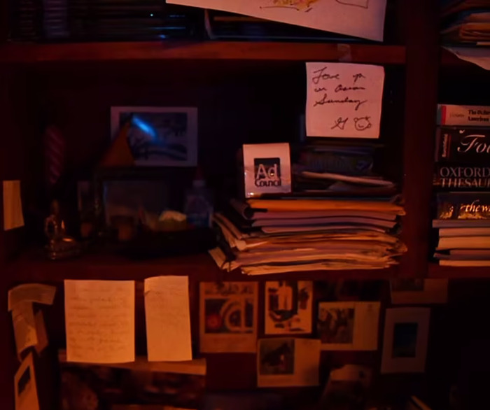 Handwritten notes to Betsy by Gene Hackman on a cluttered desk, surrounded by books and papers. Handwritten notes to Betsy by Gene Hackman on a cluttered desk, surrounded by books and papers.