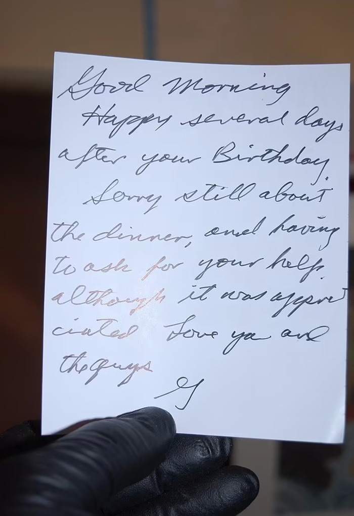 Handwritten note from Gene Hackman to wife Betsy, held by a person wearing black gloves. Handwritten note from Gene Hackman to wife Betsy, held by a person wearing black gloves.