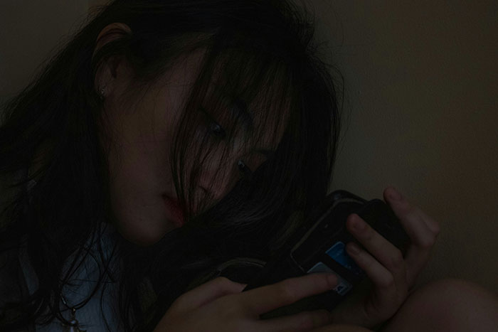 Woman intensely reading a message on her phone, related to man's ex and dates. Woman intensely reading a message on her phone, related to man's ex and dates.