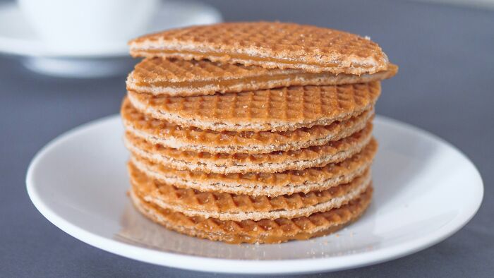 Stroopwafels, a top dish from different countries, stacked on a white plate.