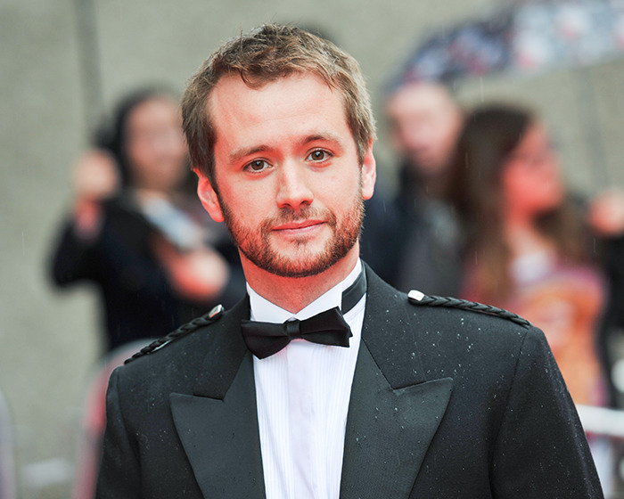 A man in formal attire with a bow tie at a red carpet event, related to a Harry Potter star's comments on JK Rowling. A man in formal attire with a bow tie at a red carpet event, related to a Harry Potter star's comments on JK Rowling.