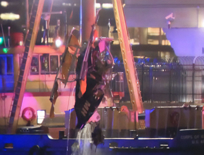 Damaged helicopter wreckage from horrific NYC crash lifted from water at night. Damaged helicopter wreckage from horrific NYC crash lifted from water at night.