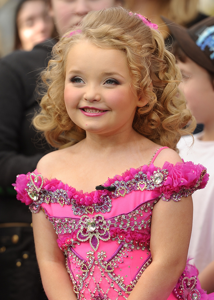 Girl in a pink embellished pageant dress, smiling brightly, representing Honey Boo Boo from "Toddlers & Tiaras. Girl in a pink embellished pageant dress, smiling brightly, representing Honey Boo Boo from "Toddlers & Tiaras.