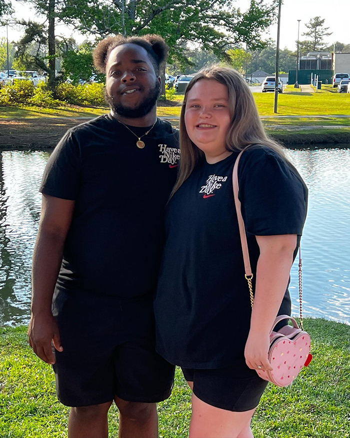 Two people smiling by a lake, both wearing black "Have a Nice Day" t-shirts, illustrating Honey Boo Boo's life changes. Two people smiling by a lake, both wearing black "Have a Nice Day" t-shirts, illustrating Honey Boo Boo's life changes.