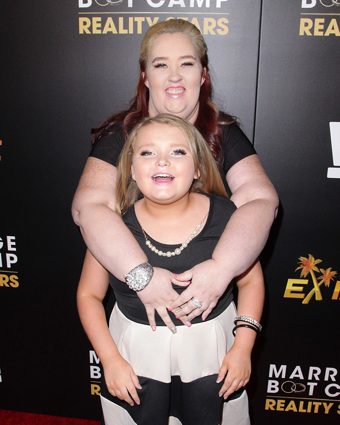 Child star with a woman at a reality TV event, showcasing Honey Boo Boo's turbulent life after 'Toddlers & Tiaras'. Child star with a woman at a reality TV event, showcasing Honey Boo Boo's turbulent life after 'Toddlers & Tiaras'.