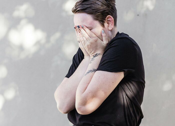 Woman in distress, covering face with hands, related to mortgage stress and expensive holiday dilemma. Woman in distress, covering face with hands, related to mortgage stress and expensive holiday dilemma.