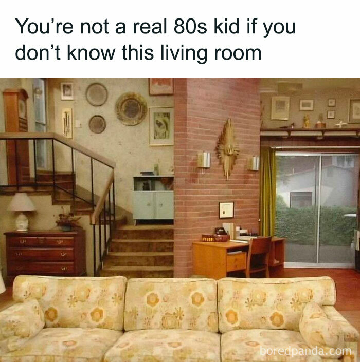 80s living room with retro decor, floral sofa, and a brick wall, evoking nostalgia for those who know floppy disks.