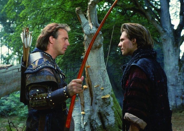 Two actors in medieval costumes stand face to face in a forest, highlighting Hollywood casting mistakes.