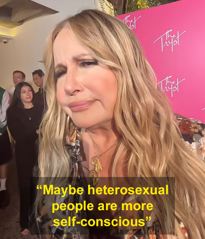 Actress at an event, responding to a question about LGBTQ+ fans with a thoughtful expression. Actress at an event, responding to a question about LGBTQ+ fans with a thoughtful expression.