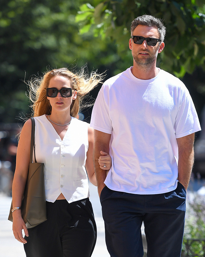 Couple walking outdoors, both wearing sunglasses. Main SEO keywords: Jennifer Lawrence, Cooke Maroney. Couple walking outdoors, both wearing sunglasses. Main SEO keywords: Jennifer Lawrence, Cooke Maroney.