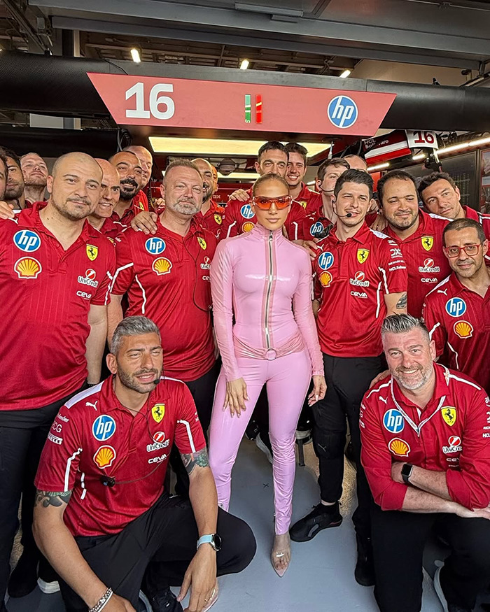 Person in pink catsuit with Ferrari team at Saudi F1 race. Person in pink catsuit with Ferrari team at Saudi F1 race.