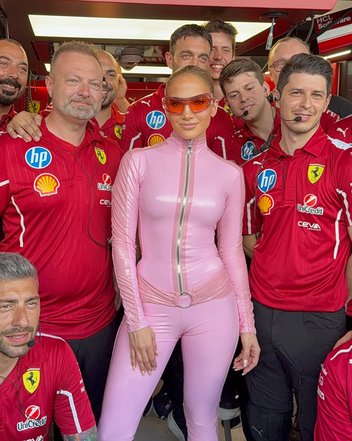 Person in pink catsuit with Ferrari team at the Saudi F1 race. Person in pink catsuit with Ferrari team at the Saudi F1 race.