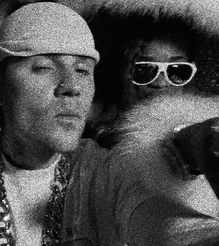 Justin Bieber kissing female rapper, both wearing sunglasses, in a grainy black and white video. Justin Bieber kissing female rapper, both wearing sunglasses, in a grainy black and white video.