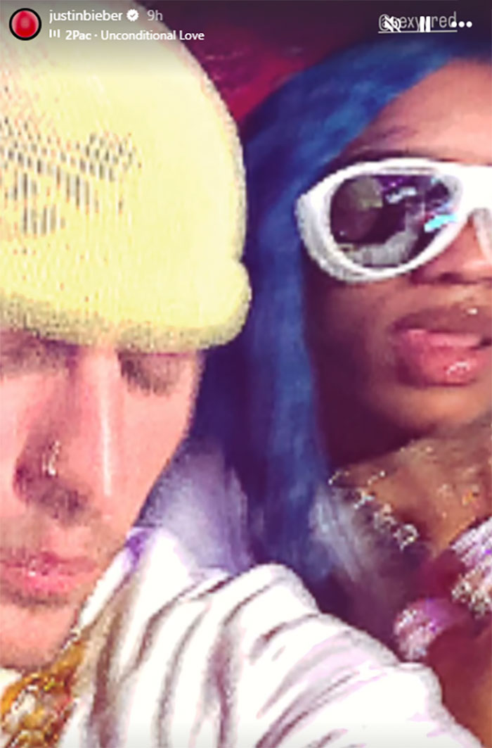 Justin Bieber with female rapper, sharing a moment, both wearing trendy accessories. Justin Bieber with female rapper, sharing a moment, both wearing trendy accessories.