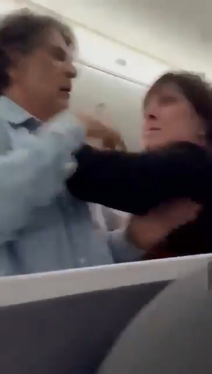 Passenger tries to storm cockpit during flight delay, getting tackled by crew amid onboard confrontation. Passenger tries to storm cockpit during flight delay, getting tackled by crew amid onboard confrontation.