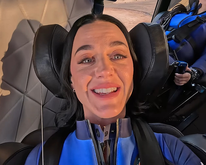 Person smiling in Blue Origin spacecraft seat, wearing a blue suit, ready for a suborbital adventure. Person smiling in Blue Origin spacecraft seat, wearing a blue suit, ready for a suborbital adventure.
